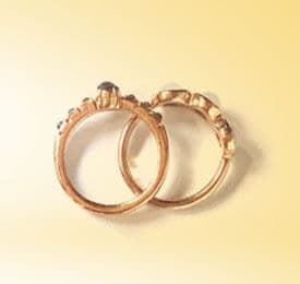Gold Classic Engagement Rings photographed on a plain background